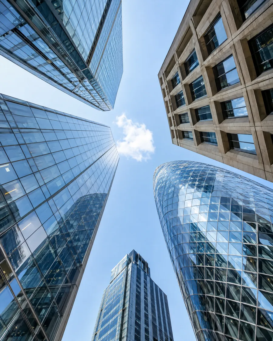 Looking up at glass office towers in the City of London